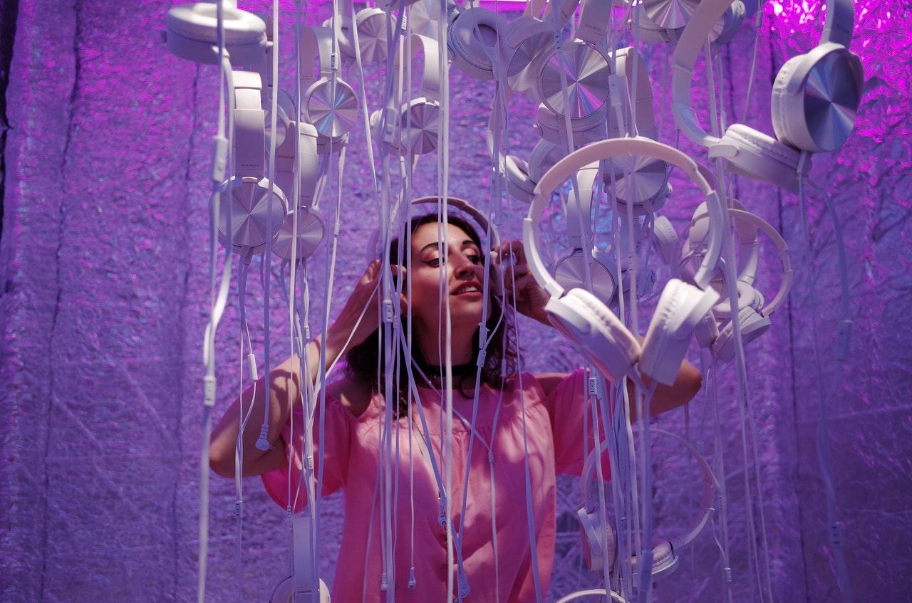 Woman standing in music installation with headphones